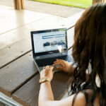 Person comparing a dealership and online car delivery options