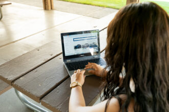 Person comparing a dealership and online car delivery options