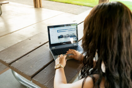 Person comparing a dealership and online car delivery options
